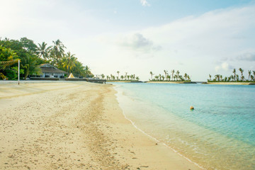 Amazing island in the Maldives , ,white sandy beach  and beautiful  turquoise waters with  blue sky  background for holiday vacation .