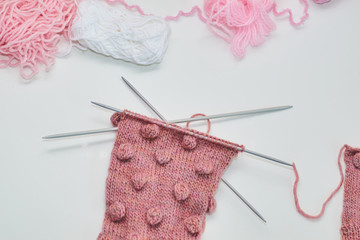 ball of yarn and knitting needles  a white background