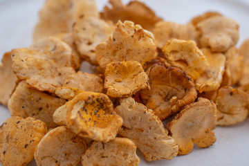 Raw wild mushrooms chanterelles in bowl on old wooden backgroundRaw wild mushrooms chanterelles in bowl on old wooden background