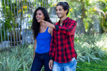 Laughing brazilian hipster couple in city