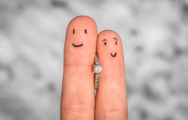 Enamored fingers with engagement ring