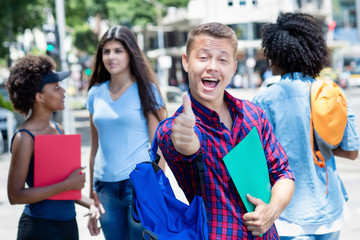 Successful brazilian male student with group of students