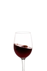 splash of red wine in glass isolated on white background.