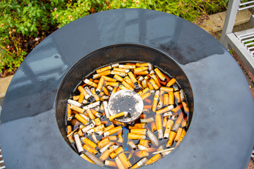 Closeup view of ashtray filled with water after rainshowers
