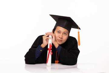 Asian Graduate man in cap and gown smile with certificated or diploma so proud and happiness in Graduation day,Isolated on white Background,Education Graduation Concept