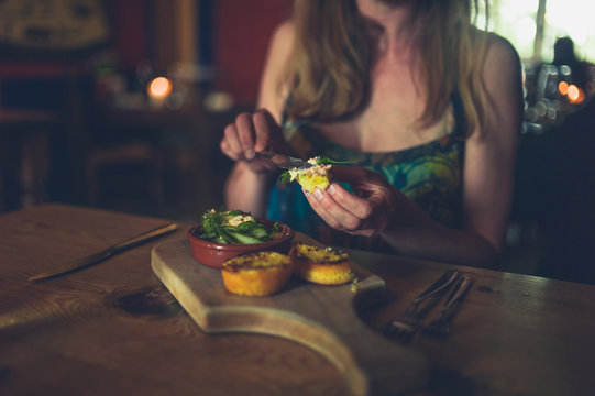 Young woman eating in restaurant