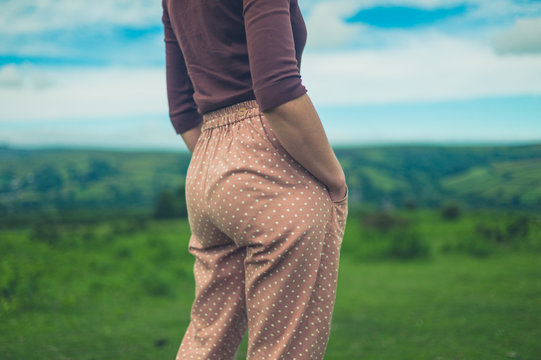 Woman with hands in pocket on the moor