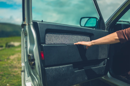 Hand And Arm Of Young Woman Closing Car Door