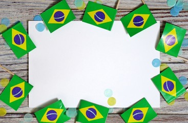 September 7. Independence day of Brazil, the concept of independence , patriotism and freedom. Mini paper flags with confetti and white postcard on wooden background