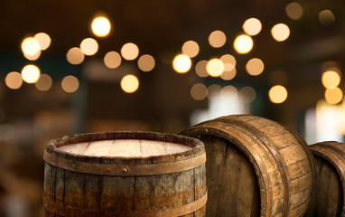 Oktoberfest beer barrel and beer glasses with wheat and hops on wooden table