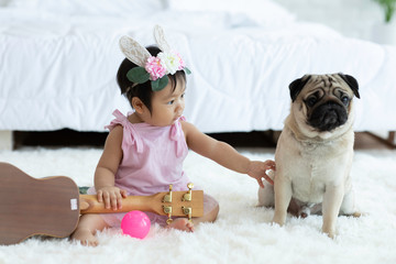 Cute Sweet Adorable Asian Baby wearing white dress Sitting on white bed smiling and playing with happiness emotional in cozy bedroom,Healthy Baby Concept