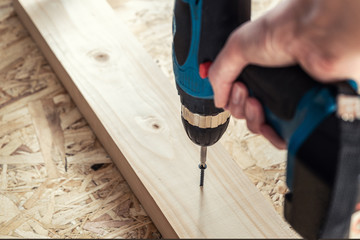 Girl the carpenter screwed a screw with a screwdriver