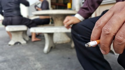 people holding cigarette in hand