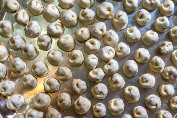 Preparing fresh tortellini stuffed with meat