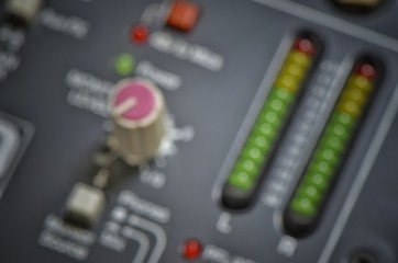 closeup of a audio mixer control panel blurred background