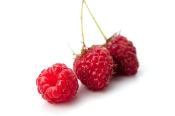 ripe raspberries isolated on white background close up