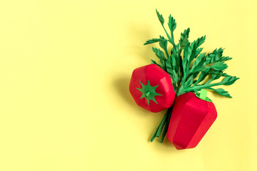 Paper tomato, pepper and parsley on yellow background