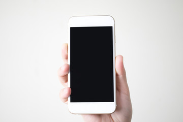 Hands holding a smart phone with a black screen at isolated background.