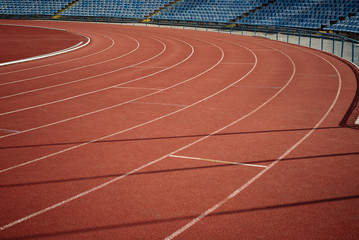Sport. A red treadmill or athletics track at the stadium. Copy space