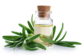 Bottle with essential oil and rosemary isolated on white background.