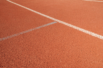 Sport. A red treadmill or athletics track at the stadium. Copy space