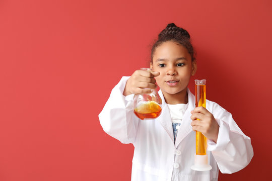 Little African-American scientist on color background