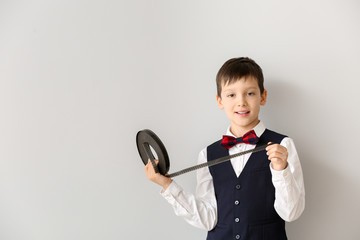Little boy with film strip on white background