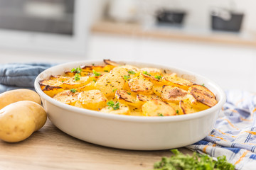 Roasted potatoes with spices and herbs on kitchen table