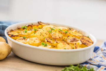 Roasted potatoes with spices and herbs on kitchen table