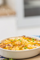 Roasted potatoes with spices and herbs on kitchen table