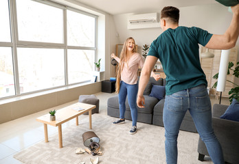 Young quarrelling couple at home