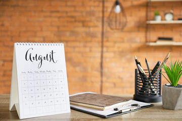 Flip paper calendar and stationery on office table