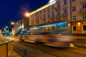 The motion of a blurred tram in the evening.