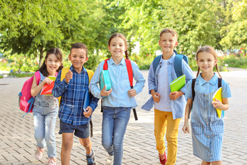 Group of cute little pupils outdoors