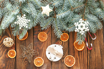 Christmas tree branches and decor on wooden background