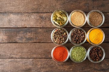 Various kinds of colourful seasonings in bowls. Collection of spices