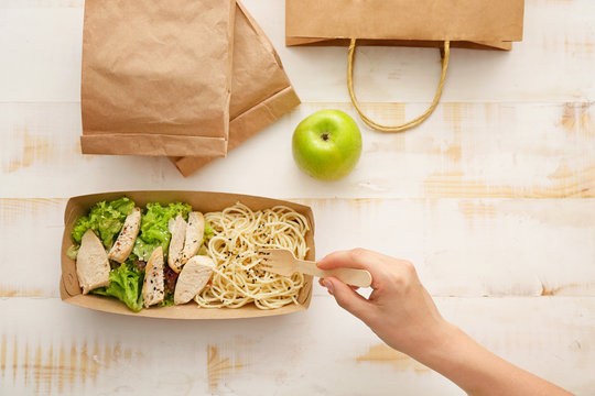 Woman eating tasty lunch ordered from food delivery service