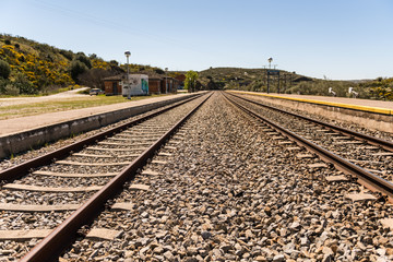 Fototapeta premium Oxidized railway tracks next to the abandoned Rio Tajo train station, near Garrovillas de Alconetar