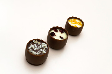 three chocolate filled bonbons sweets with selective focus