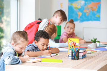 Cute little pupils in classroom