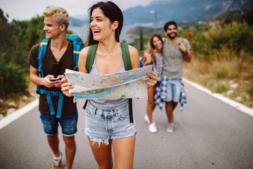 Group of backpackers and young friends traveling and having fun together