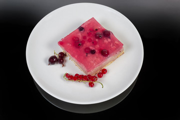 Top view of layered cake slice with berries and jelly