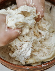 baby hands knead the dough in a pizza plate