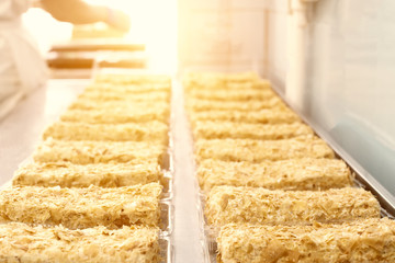 Cake Napoleon with condensed milk and puff pastry. Confectioner makes cake, sun, crispy