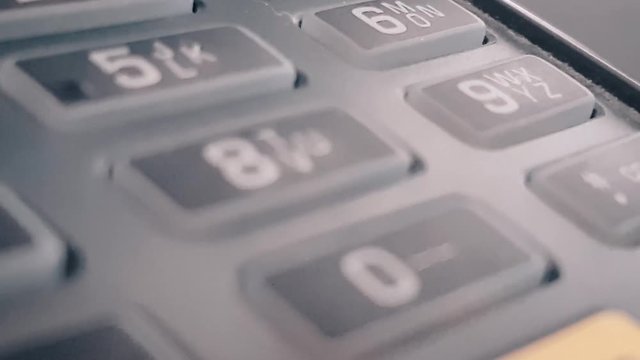 Macro closeup review of the pos terminal and pin pad numbers. Leading to cancel button. Keyboard on black POS terminal.