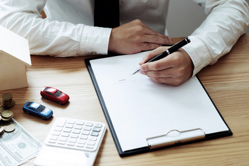 Life protection concept, Businessman or Insurance agent with small house model and Car with documents.