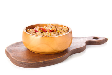Bowl with tasty sweet oatmeal on white background