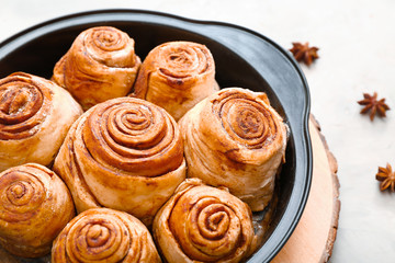 Tasty cinnamon buns in baking tray, closeup
