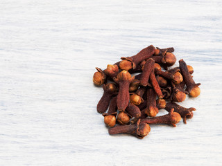 Clove spice on white wooden background