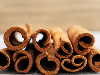 Spice cinnamon (Cinnamomum verum) sticks on a white and brown background. Side view. Close up